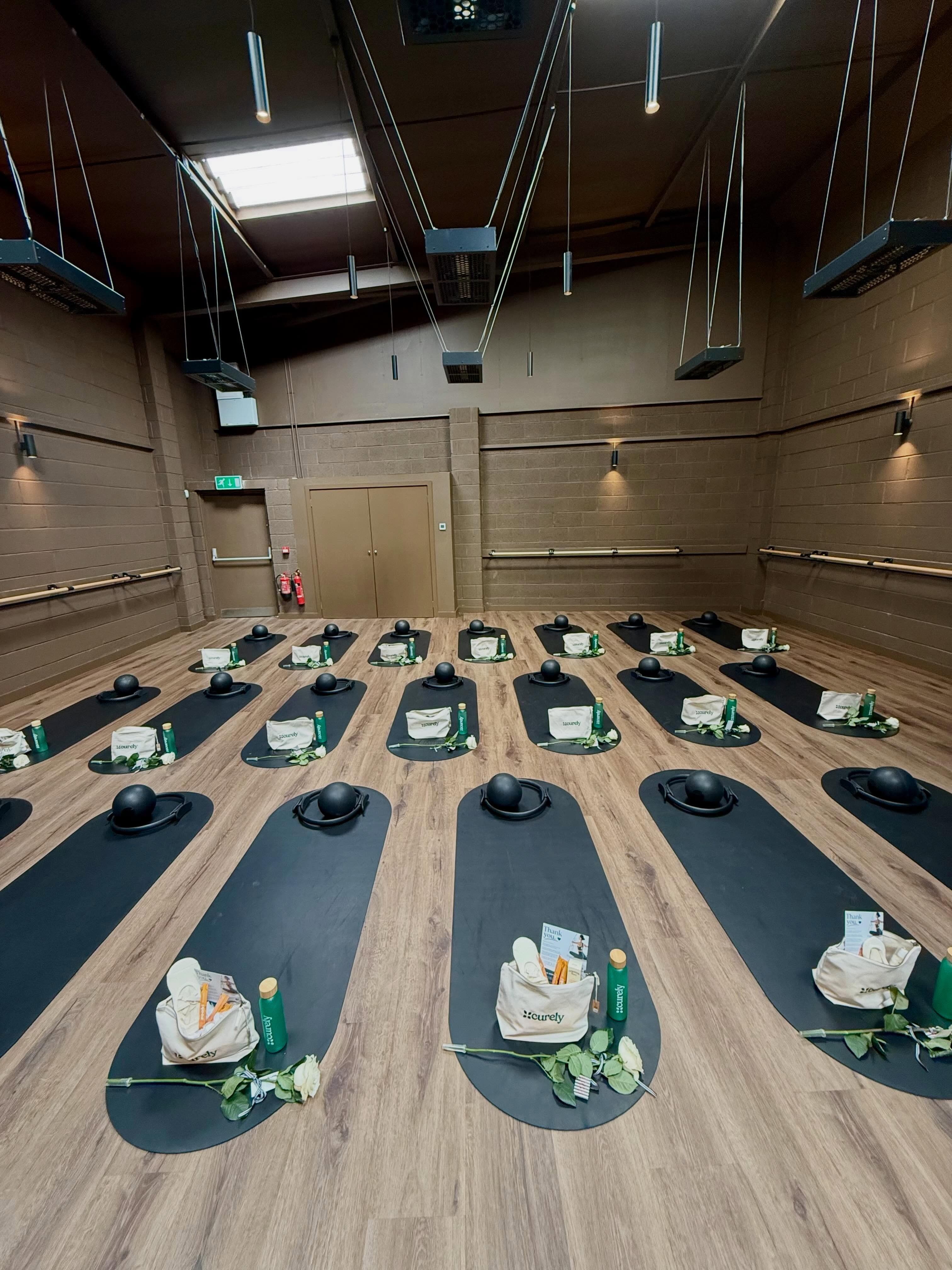 People practicing Pilates inside the glasshouse
